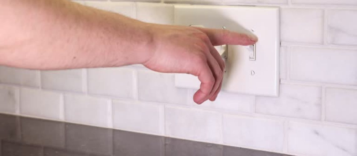 A high-resolution 4K video showing a hand flipping a wall light switch on and off. The video captures the simple yet essential action of controlling home lighting, illustrating concepts of power management, energy efficiency, and everyday household interactions. Ideal for themes related to electricity, home automation, and modern living.